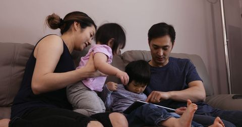 Happy Asian Family Bonding Together at Home