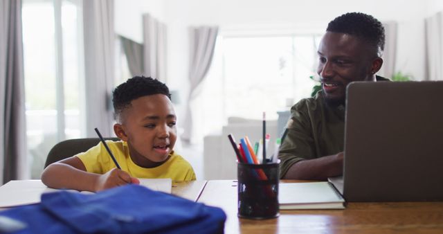 Father and Son Doing Homework Together at Home - Download Free Stock Images Pikwizard.com