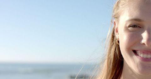 Joyful Young Woman Smiling at Sunny Beachside - Download Free Stock Images Pikwizard.com