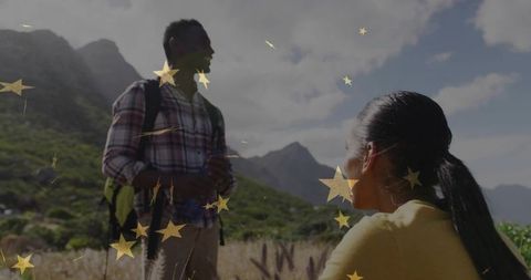 Adventurous duo exploring scenic mountain valley with gold star effects