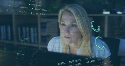 Businesswoman Analyzing Financial Data on Digital Screen