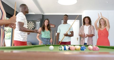 Diverse Friends Enjoying Billiards Game in Relaxed Atmosphere