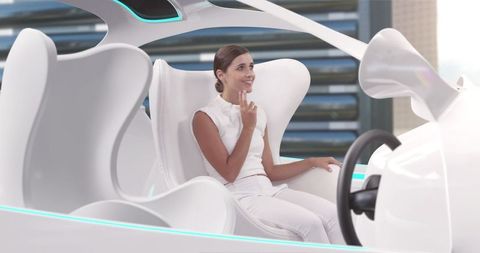 Woman experiencing autonomous driving in futuristic car interior