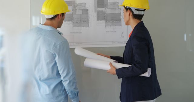 Engineers examining construction plans on site - Download Free Stock Images Pikwizard.com