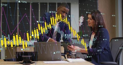 Business professionals analyzing financial charts in boardroom