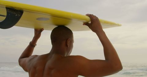 African American Surfer Carrying Surfboard by Ocean Shore - Download Free Stock Images Pikwizard.com