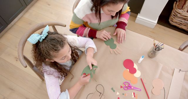 Two Girls Engaged in Arts and Crafts at Home Table - Download Free Stock Images Pikwizard.com