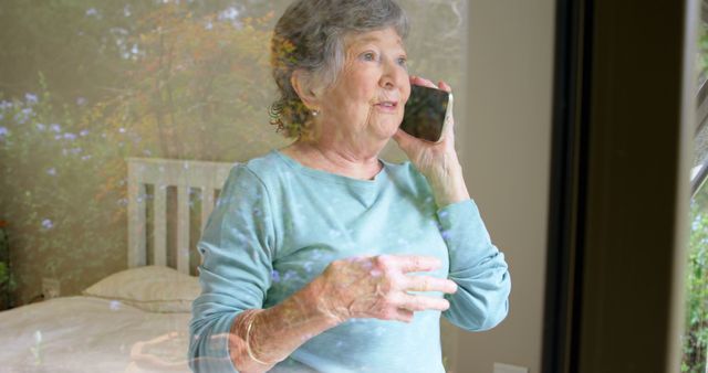 Elderly Woman Talking on Smartphone Through Window - Download Free Stock Images Pikwizard.com