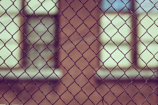 Closeup Wire Fence with Blurred Building Background - Download Free Stock Photos Pikwizard.com