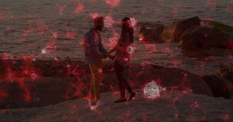 Couple connects on rocky shoreline at dusk with neural network overlay