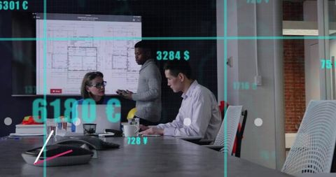 Team analyzing architectural plans in modern conference room