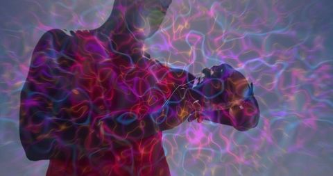 African American man holding VR headset with psychedelic light overlays, futuristic vibe