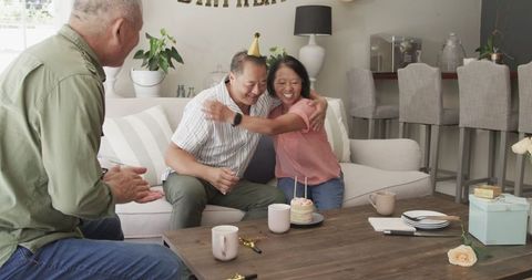 Seniors Celebrating Birthday at Home with Loved Ones and Cake