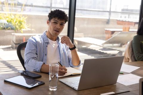 Young Professional Engaging in Office Work at Modern Workspace