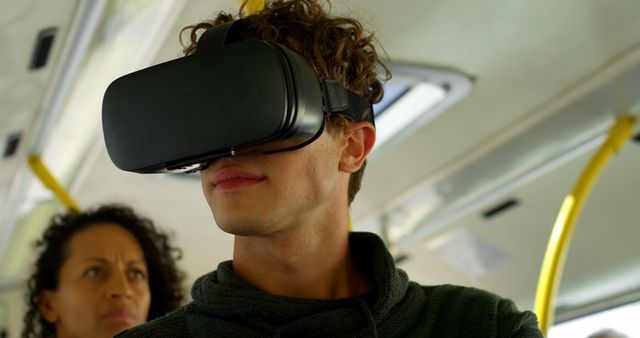 Young Man Wearing VR Headset on Public Transportation - Download Free Stock Images Pikwizard.com