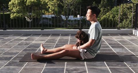 Relaxed sitting with puppy on outdoor mat