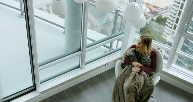 Woman Relaxing by Large Window in Modern Apartment - Download Free Stock Images Pikwizard.com