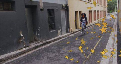 Urban Cyclist Navigating Star-Filled Alleyway