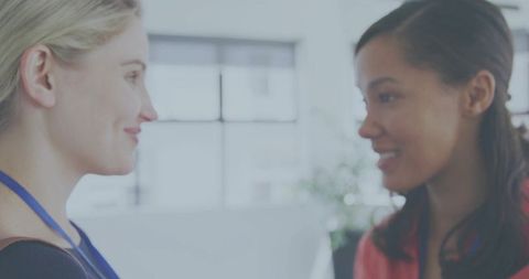 Colleagues talking and smiling in bright modern office for teamwork and collaboration