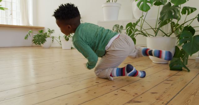 Playful Child Slips and Falls on Wooden Floor - Download Free Stock Images Pikwizard.com