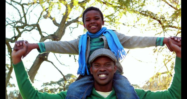 Father Carrying Son on Shoulders in Sunny Park - Download Free Stock Images Pikwizard.com