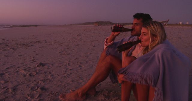 Couple Relaxing on Beach at Sunset with Beers - Download Free Stock Images Pikwizard.com