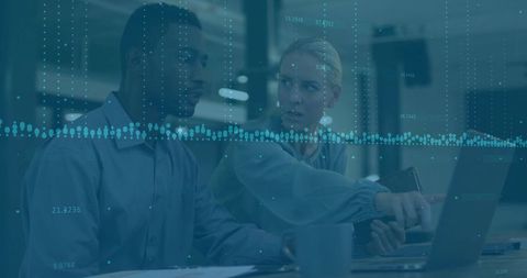 Colleagues Analyzing Data on Laptop and Tablet in Modern Office