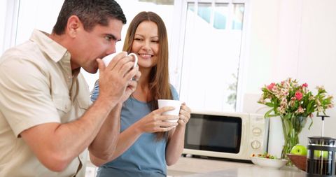 Happy Couple Enjoying Coffee in Modern Kitchen
