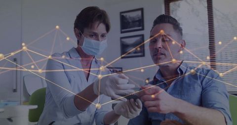 Healthcare Professional Discussing Treatment with Patient Using Digital Tablet