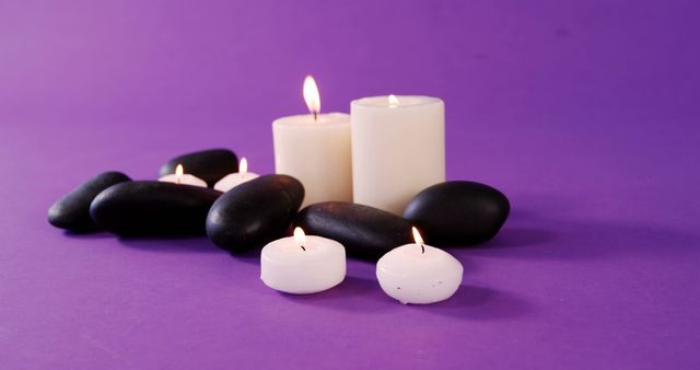 Aromatherapy Candles and Relaxation Stones on Purple Background - Download Free Stock Images Pikwizard.com