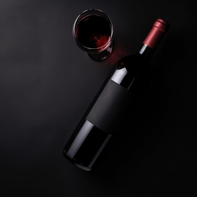 Wine bottle and glass with red wine on black background, created using generative ai technology - Download Free Stock Photos Pikwizard.com