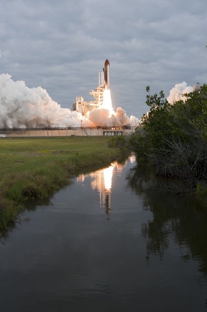 Space Shuttle Endeavour is seen taking off from Launch Pad 39A at NASA's Kennedy Space Center for its final mission on May 16, 2011. The image captures the striking contrast between advanced space technology and the serene environment of the Merritt Island National Wildlife Refuge. This photograph embodies the spirit of human innovation and can be used in articles and educational material about space missions, space shuttle history, or conservation efforts near technological facilities.