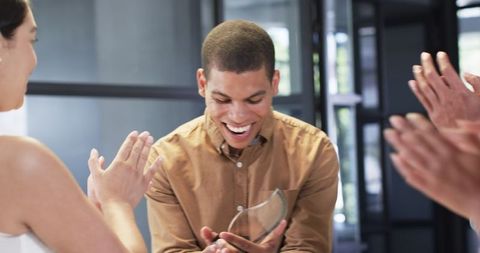 Colleagues celebrating corporate achievement in office