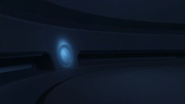 Glowing blue mesh grille casting halo on curved futuristic pod wall with recessed vent