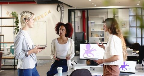 Businesswomen Collaborating During Meeting in Modern Office Environment