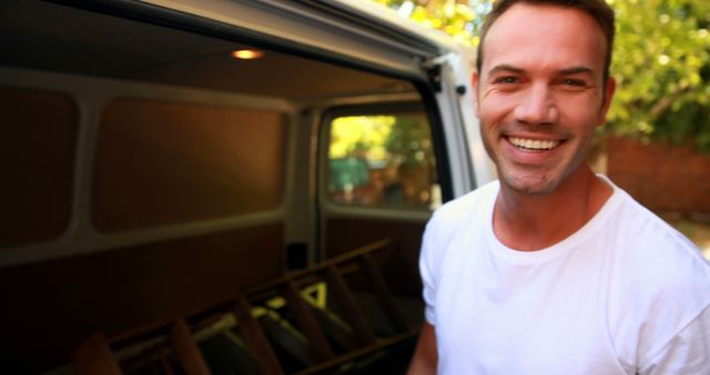 Smiling Painter Standing Next to Van in Outdoor Setting - Download Free Stock Images Pikwizard.com