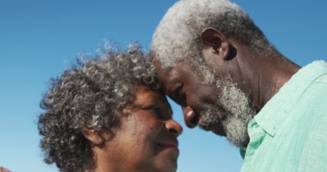 Senior Couple Embracing Outdoors Against Clear Blue Sky - Download Free Stock Images Pikwizard.com