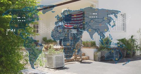 Standing service member holding american flag on porch with world map overlay symbolizing unity