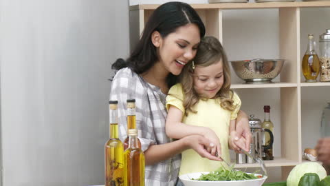 Mother and Daughter Bonding While Preparing a Salad Together