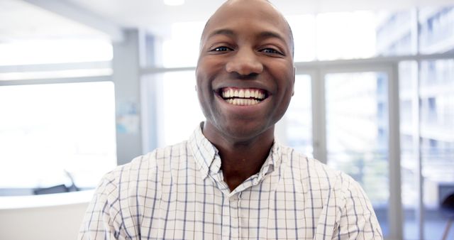 Smiling African American Man in Checkered Shirt at Modern Office - Download Free Stock Images Pikwizard.com