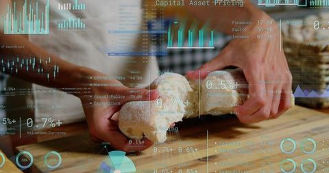 Hands tearing rustic sourdough loaf on cutting board with digital financial hud overlay