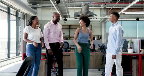 Joyful Team Celebrating Success in Modern Office Environment