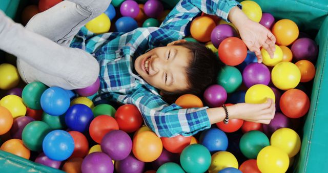 Joyful Child Playing in Ball Pit at Indoor Playground - Download Free Stock Images Pikwizard.com