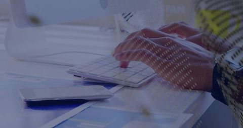 Typing Hands on White Keyboard with Smartphone and Financial Charts, Modern Workspace