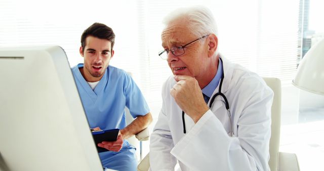 Senior Doctor Analyzing Data with Young Nurse in Hospital - Download Free Stock Images Pikwizard.com