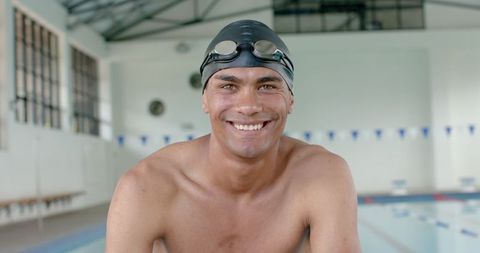 Confident Swimmer Smiling at Poolside Before Competition Start