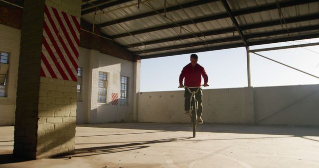 Confident Man Practicing BMX Stunts in Urban Indoor Space - Download Free Stock Images Pikwizard.com