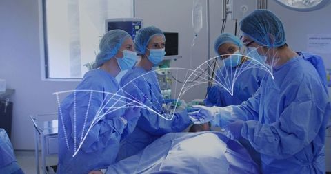 Surgical team performing operation in sterile operating room with real-time monitoring