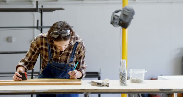 Carpenter Measuring Wood at Workshop Table with Precision Tools - Download Free Stock Images Pikwizard.com