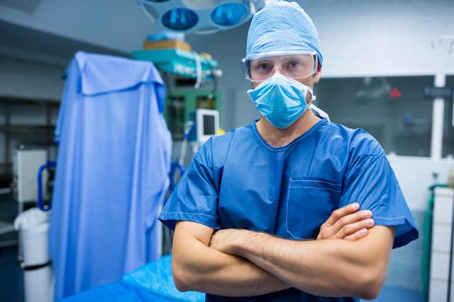 Confident Surgeon Standing with Arms Crossed in Operating Room - Download Free Stock Images Pikwizard.com